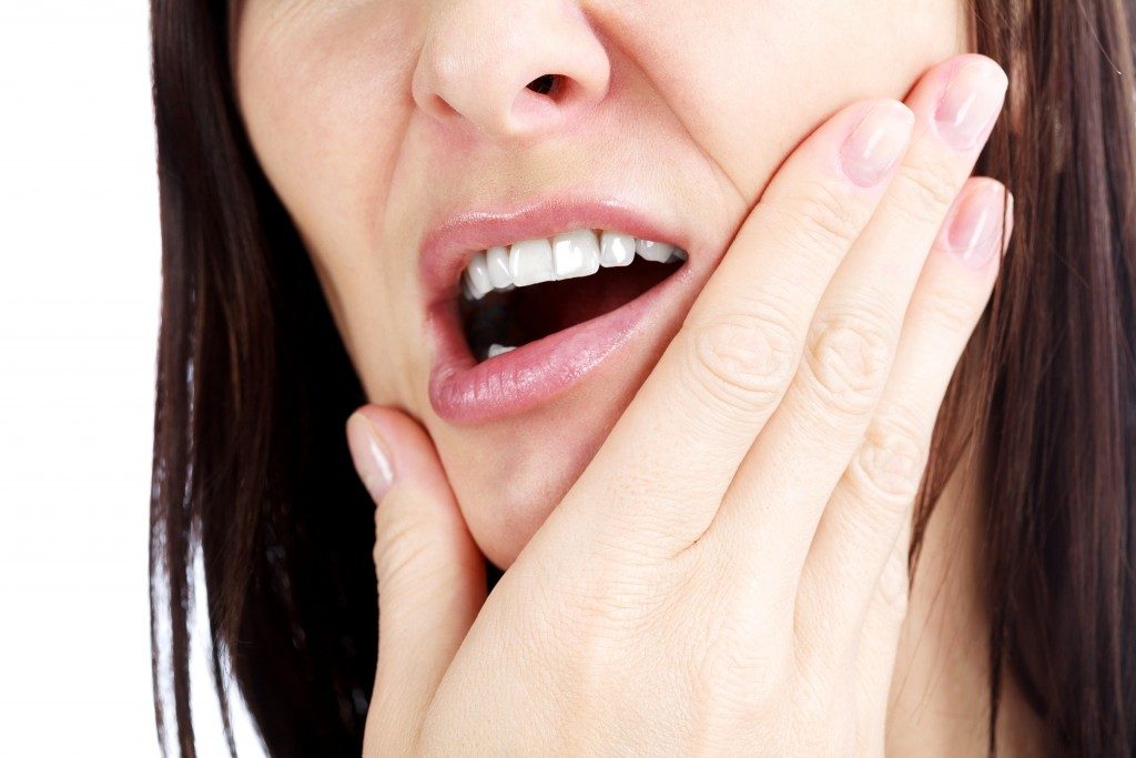 Woman with growing wisdom tooth