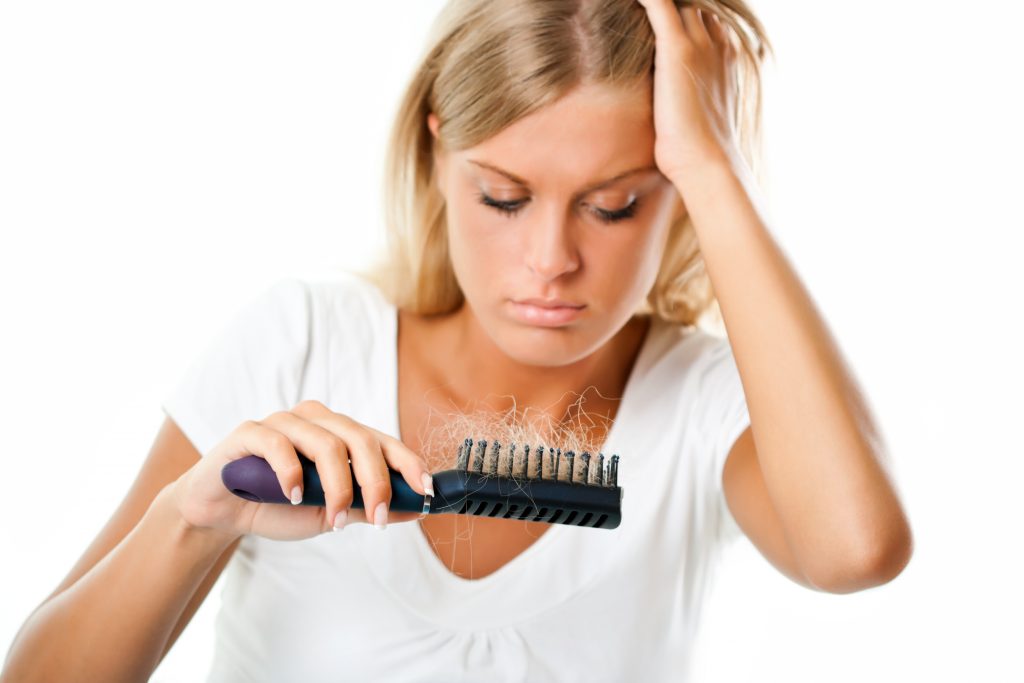 a woman worried about hair loss