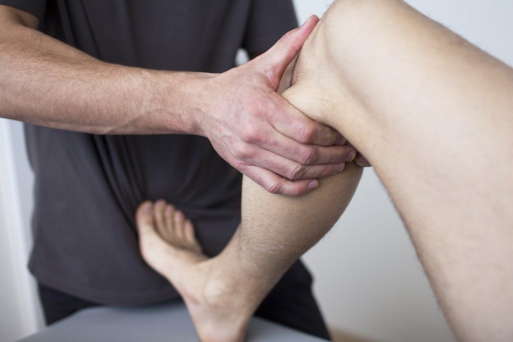Physiotherapist cracking a leg