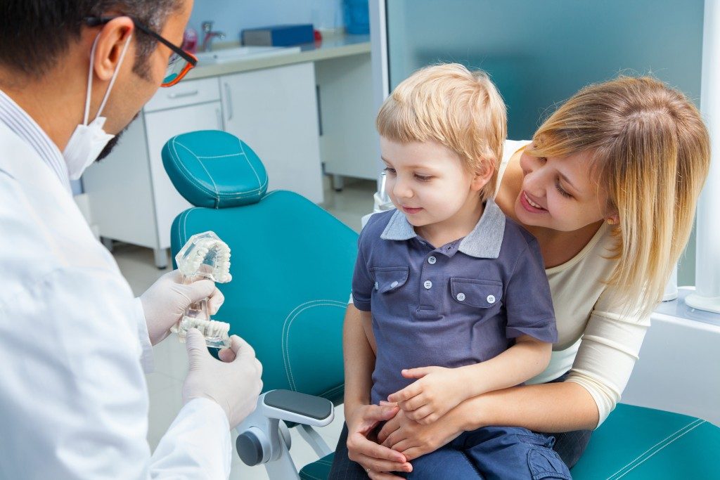 Mother and son visit with dentist