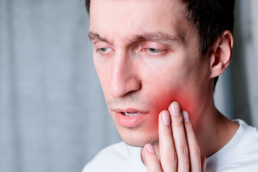 man having a tooth pain