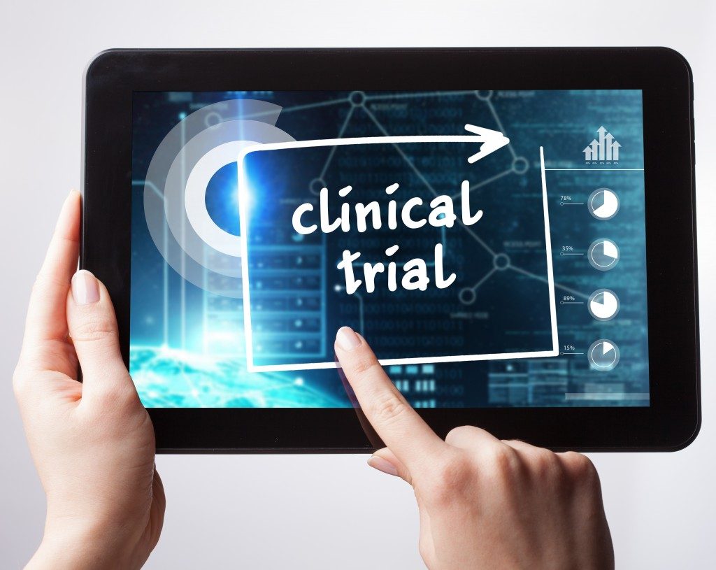 person tapping on clinical trial concept on tablet