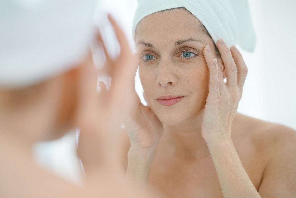 woman putting face cream