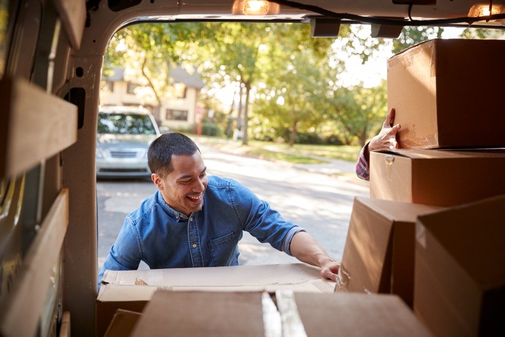 man loading boxes in van