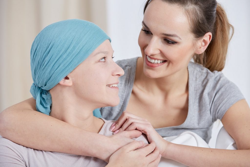 woman hugging a person with cancer