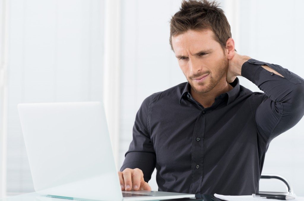 Man overworked with a hurting neck