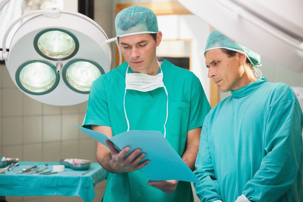 surgeons looking at patient file