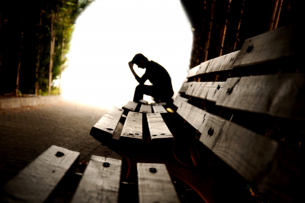 silhouette of man in a bench