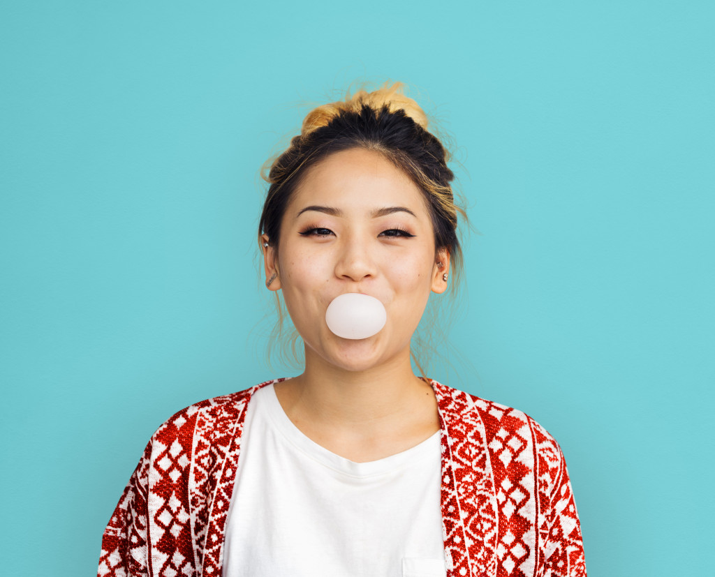 woman blowing bubble gum