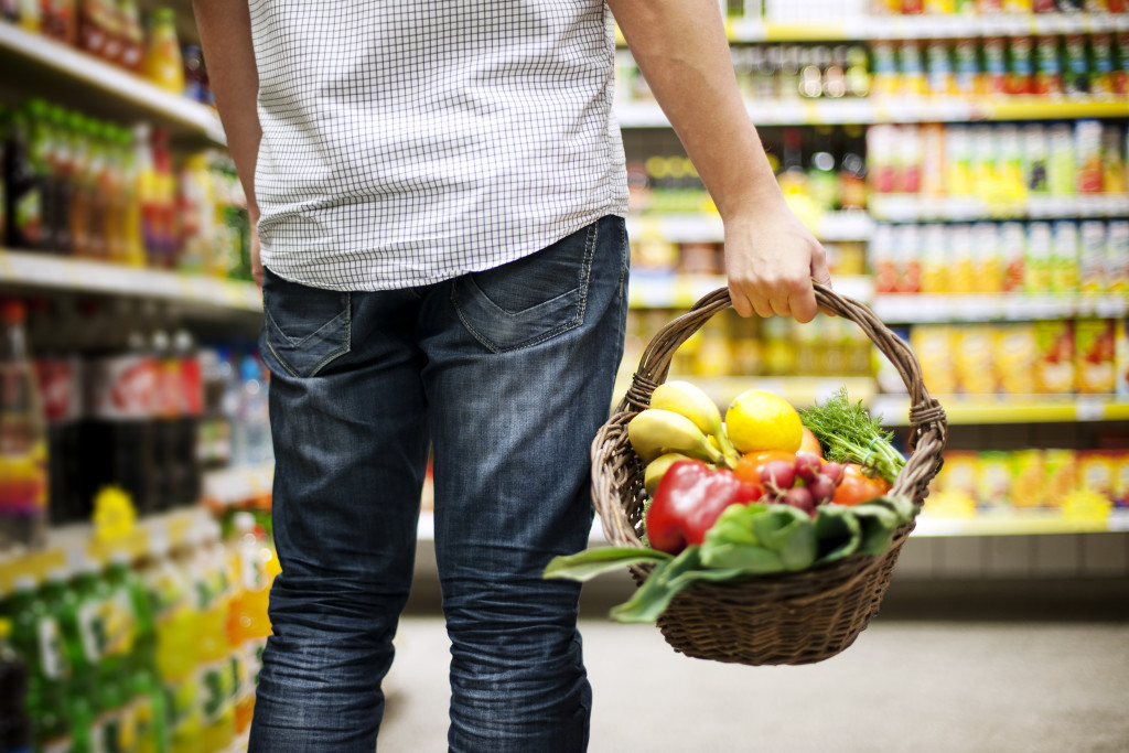 holding a basket of healthy fruits and vegetables