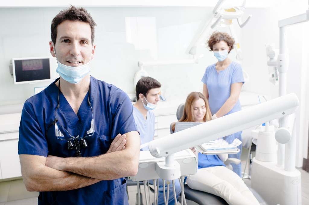 A group of dental professionals checking on a patient