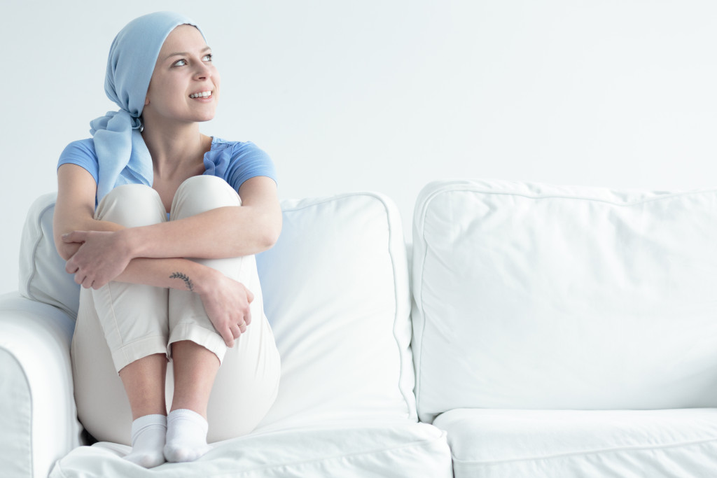 A woman with cancer sitting on couch