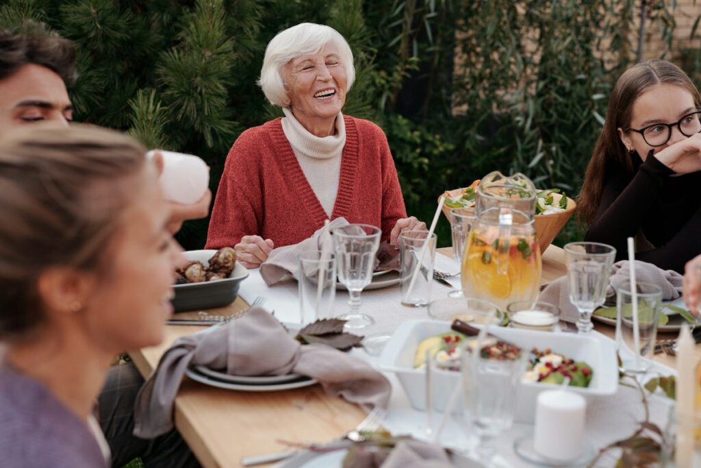 Happy family enjoying dinner in garden