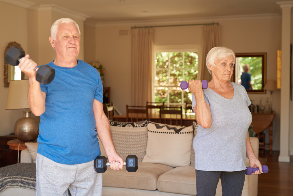 male and female in their 50s exercising at home