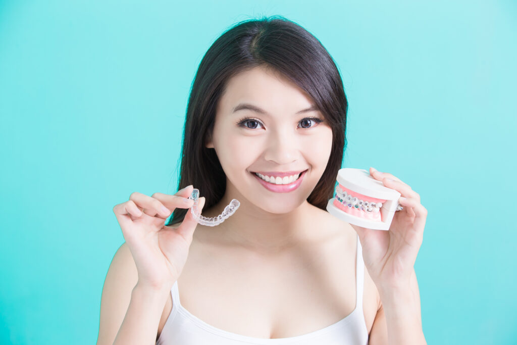 woman holding invisble retainers